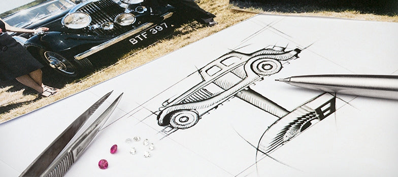 Pencil sketch of a vintage car on paper with tweezers, a pen and loose rubies and diamonds