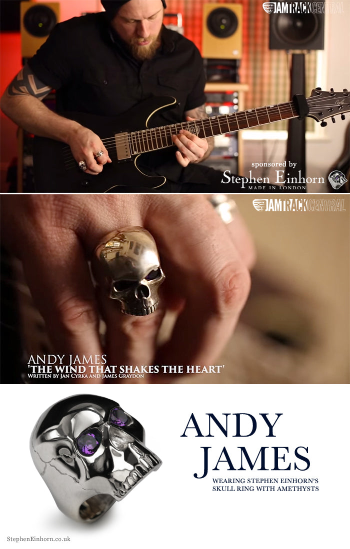 Guitarist Andy James playing an electric guitar, wearing a silver skull ring with amethyst eyes