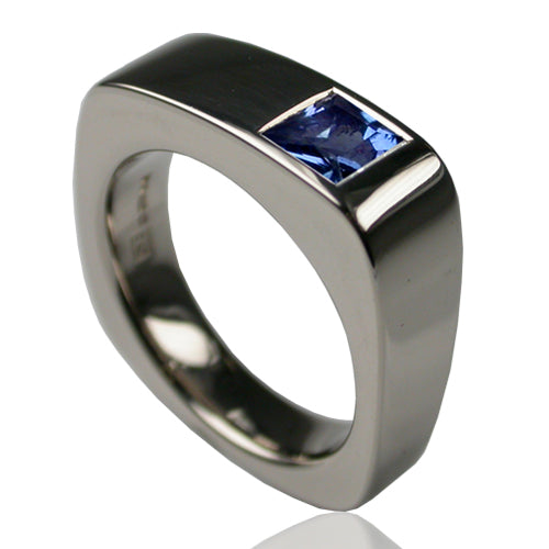 Jump 5 ring in 18ct white gold with a princess cut blue sapphire set flush in the square band