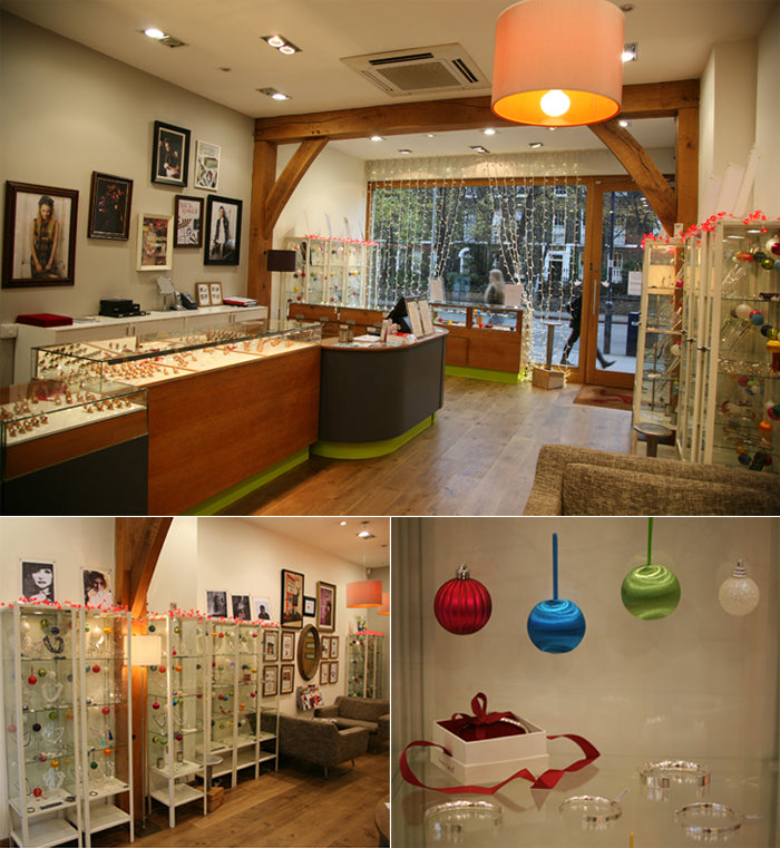 Our London shop at Christmas: jewellery counters, glass display cabinets and red, blue and green baubles