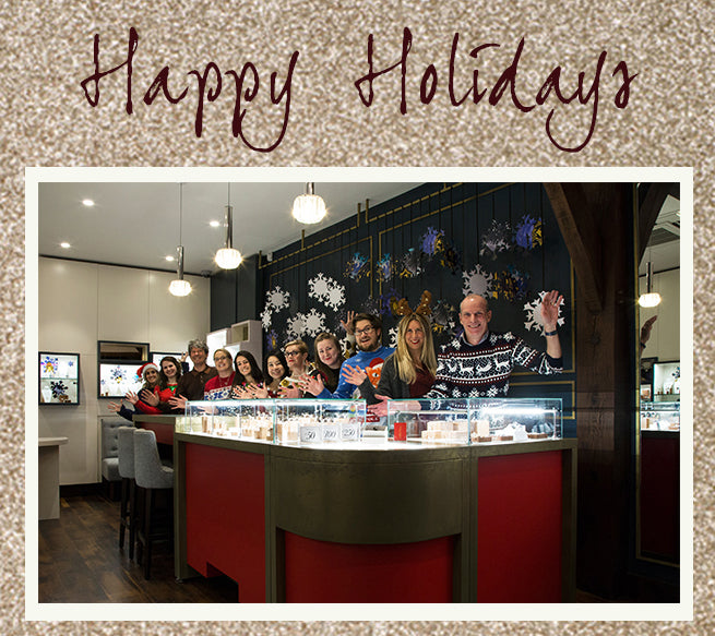 Happy Holidays card showing our team behind the counter of the London shop in festive jumpers