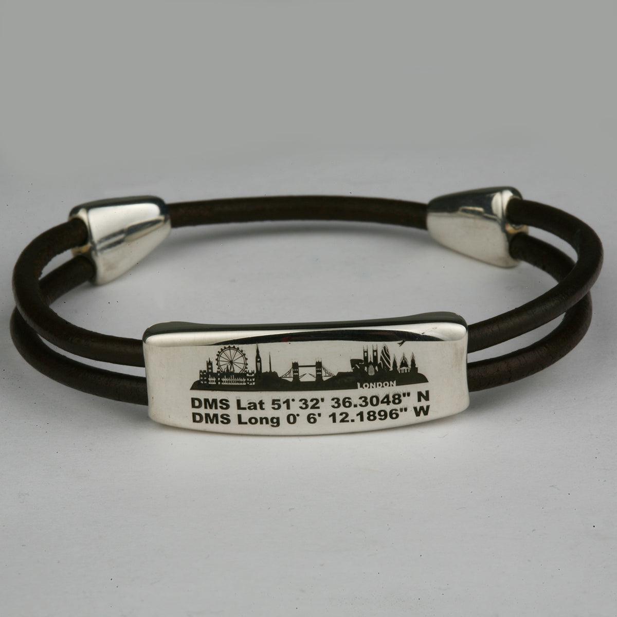 Silver bar on a double brown leather cord bracelet, engraved with the London skyline and map coordinates