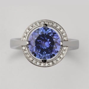 White gold ring with a large round tanzanite surrounded by a halo of small diamonds