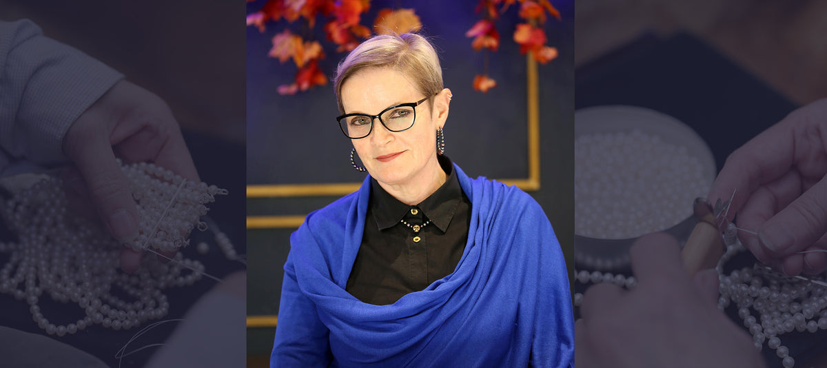 Jane Best Portrait wearing a peacock skull and pearl necktie and peacock pearl hoops