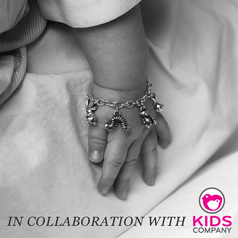 Baby's hand wearing a silver charm bracelet with animal charms, captioned In collaboration with Kids Company