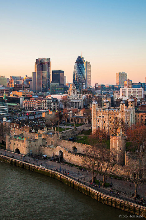 Tower of London and the Thames at dusk, with the Gherkin and City towers rising behind