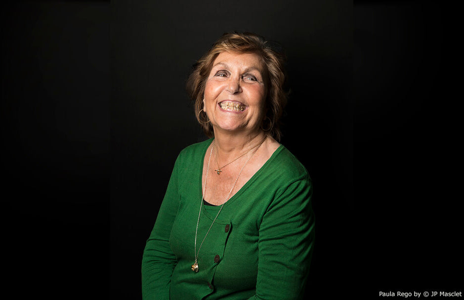 Portrait of a smiling woman in green wearing gold pendant necklaces, captioned Paula Rego by JP Masclet
