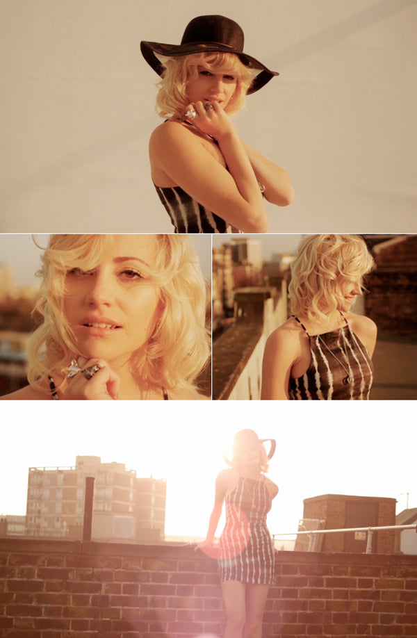 Pixie Lott in a wide-brimmed hat and striped dress wearing silver rings on a London rooftop for Vogue Italia
