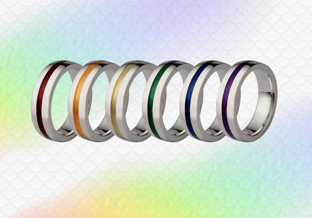 Six titanium rings each inlaid with a coloured stripe in red, orange, yellow, green, blue and purple
