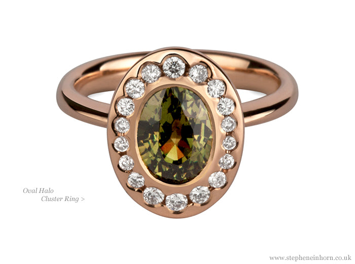 Rose gold oval halo cluster ring set with an olive green gemstone surrounded by white diamonds