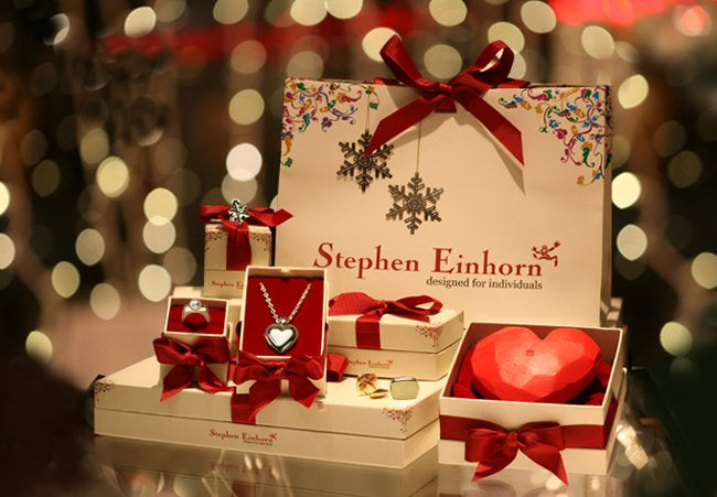 Stephen Einhorn Christmas gift boxes tied with red ribbon, with a heart pendant, ring and cufflinks