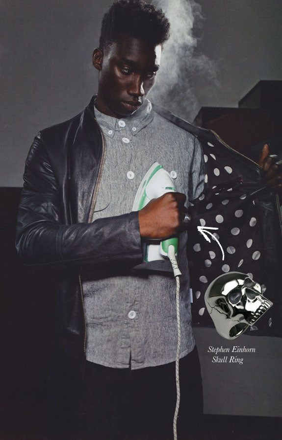 Male model ironing his shirt in a leather jacket in FHM, with an inset silver Stephen Einhorn skull ring