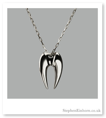 Polished silver fang pendant on a fine chain against a grey background