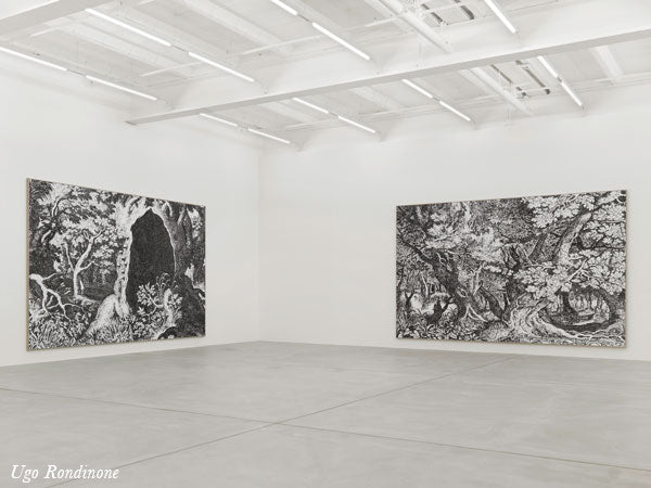 Ugo Rondinone's large black and white tree drawings hung in a white gallery space in Zurich