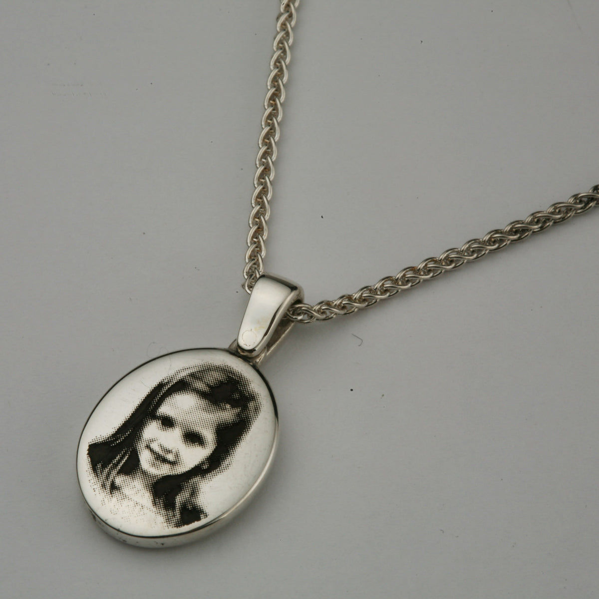Silver pendant engraved with a family photograph