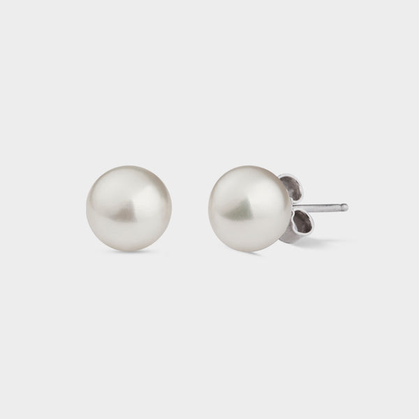 side view of a pair of betty white pearl earrings.