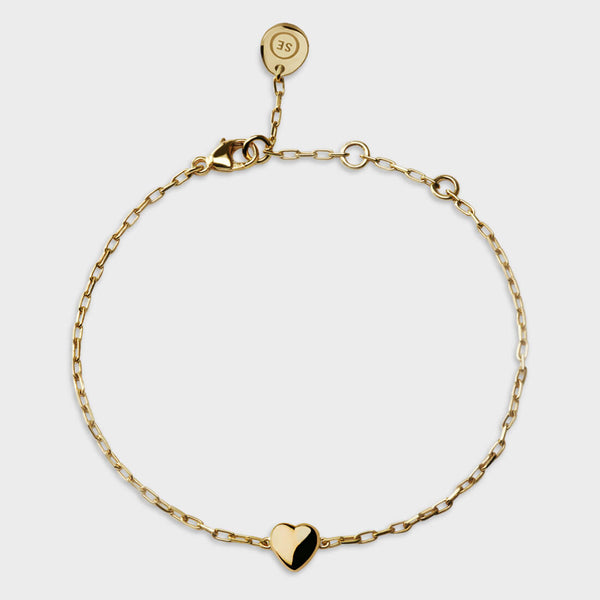 above view of a yellow gold dainty heart bracelet.