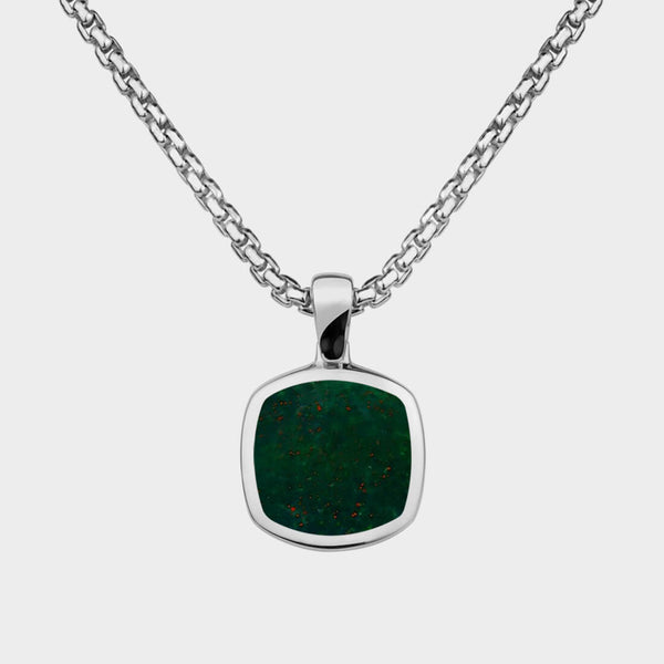Close up of a sold silver pendant necklace with a bloodstone inlay.