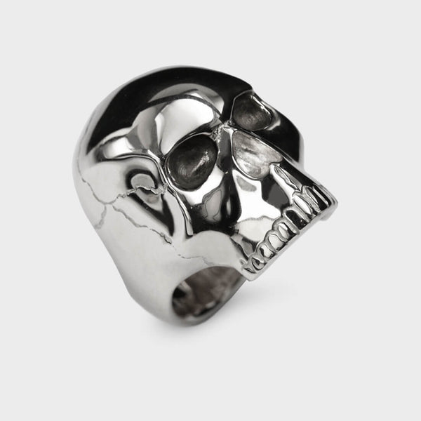 A side view of a large skull ring with anatomical detail.